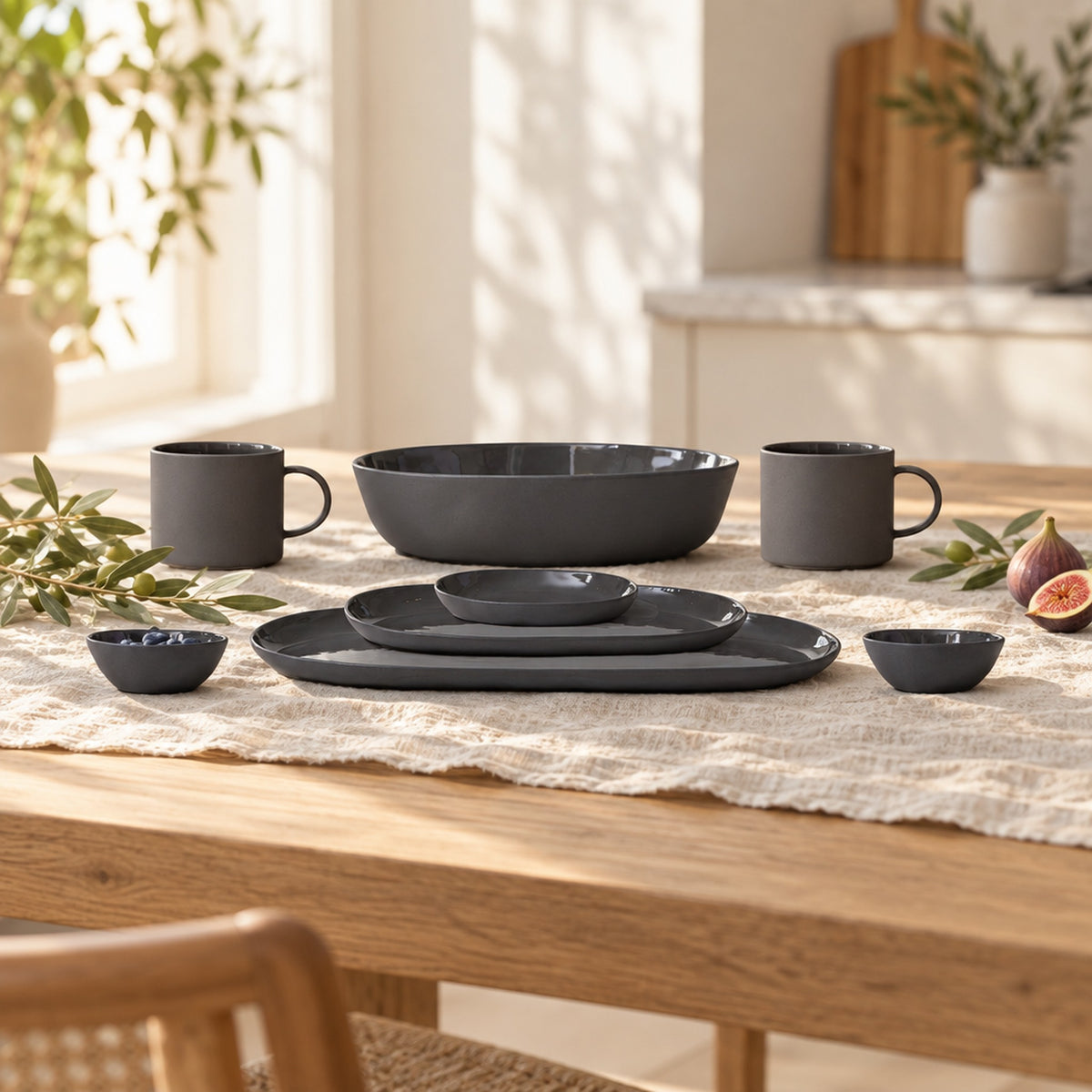 Cloud Value Set Charcoal styled on an oak dining table with linen, olive leaves and fruit