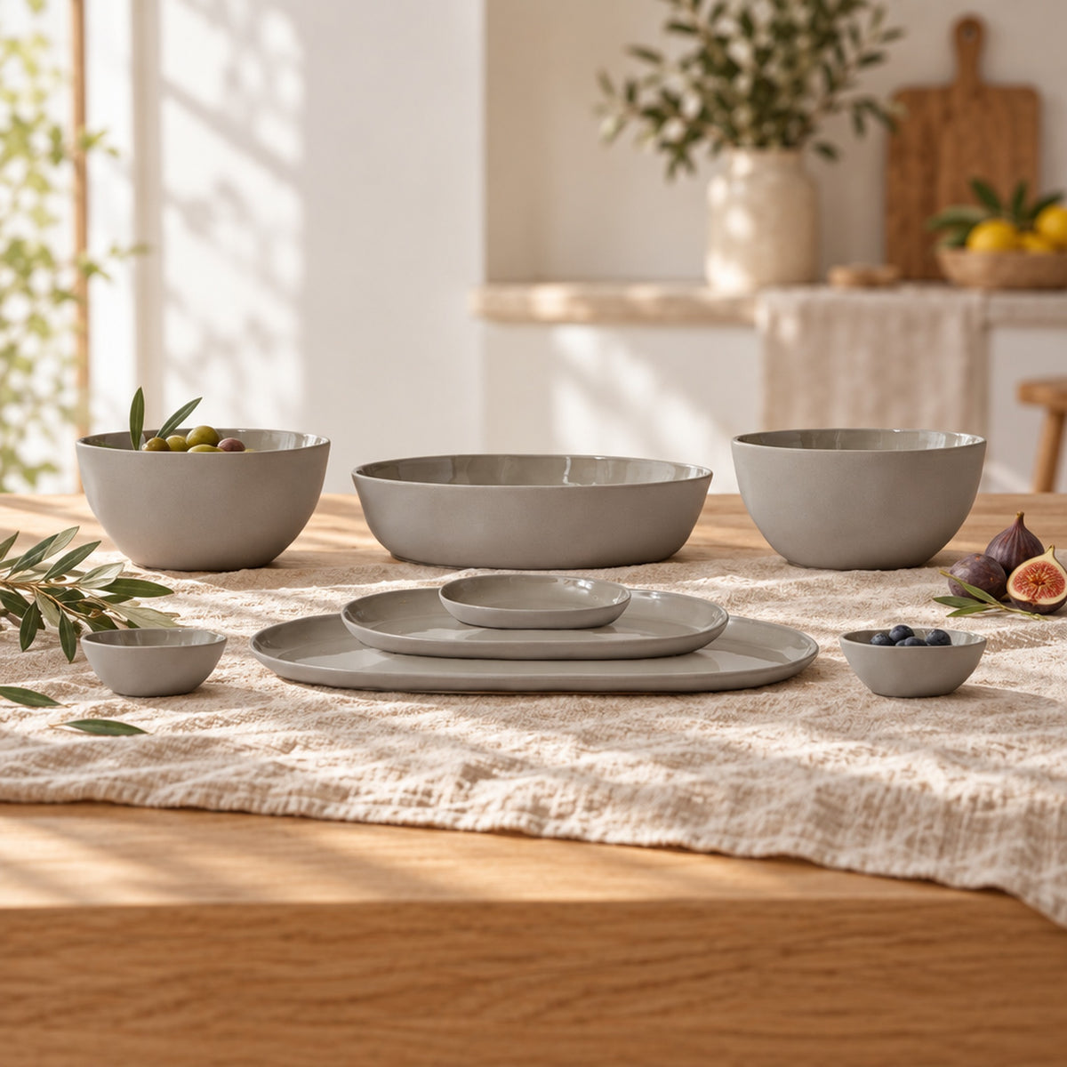 Cloud Value Set Dove Grey styled on an oak dining table with linen, olive leaves and fruit