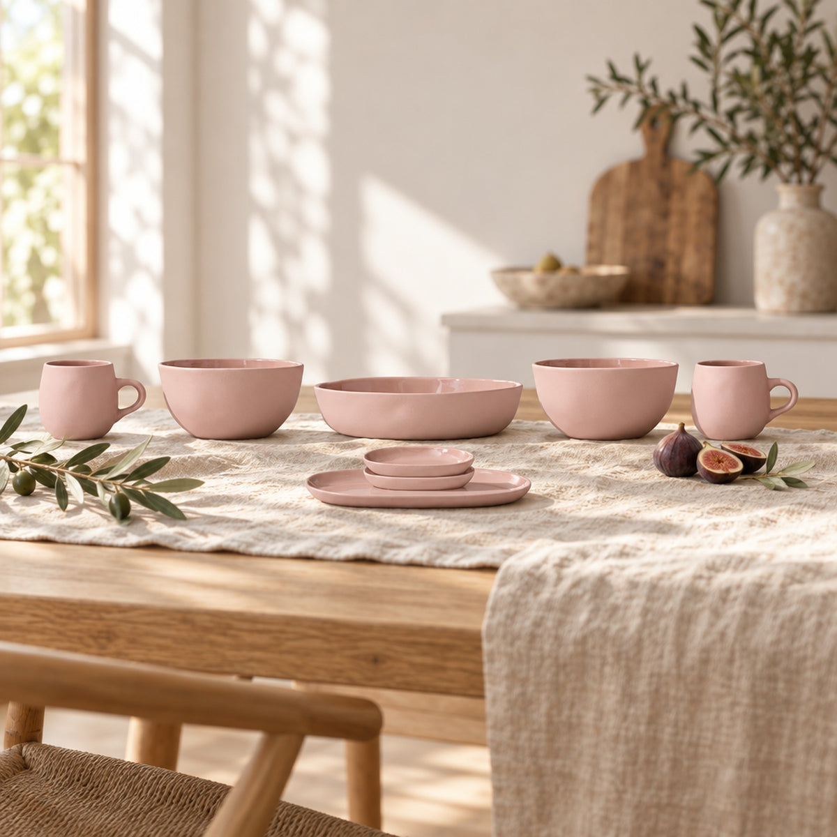 Cloud Value Set Icy Pink styled on an oak dining table with linen, olive leaves and fruit